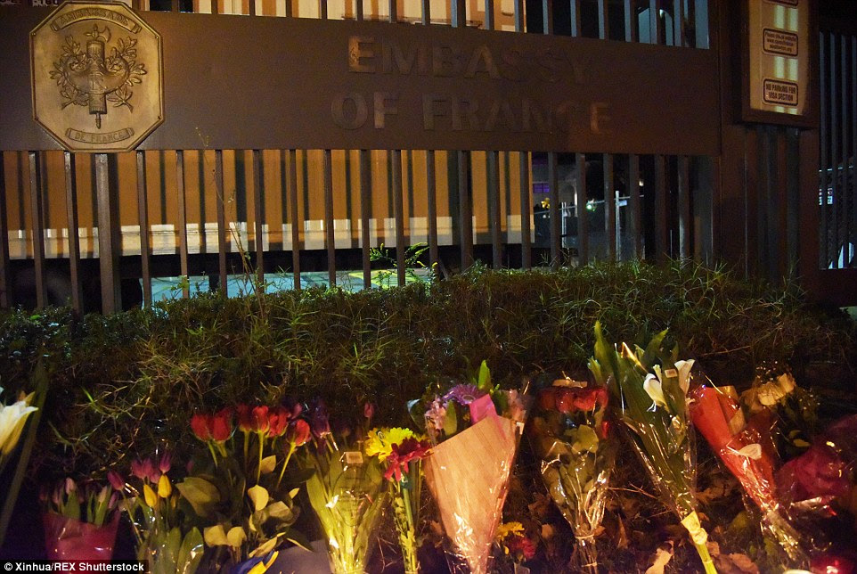 Bouquets of flowers pile up outside the French Embassy in Washington DC in honour of those killed in Paris last night