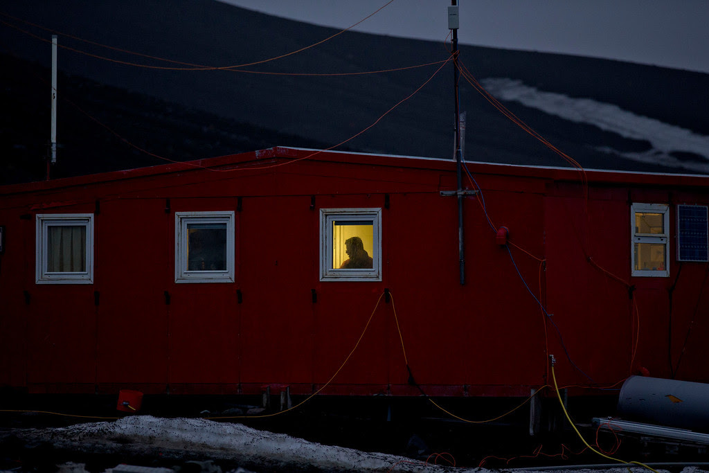 Description of . In this Jan. 24, 2015 photo, a scientist stands behind a window on the Spanish base Gabriel de Castilla on Deception Island, part of the South Shetland Islands archipelago in Antarctica. If experts are right, and the West Antarctic ice sheet has started melting irreversibly, what happens here will determine if cities such as Miami, New York, New Orleans, Guangzhou, Mumbai, London and Osaka will have to regularly battle flooding from rising seas. (AP Photo/Natacha Pisarenko)