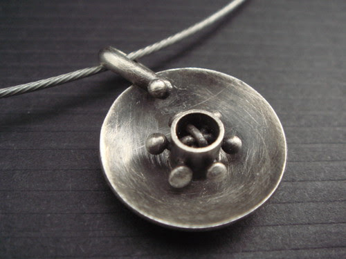 silver disk pendant with spokes