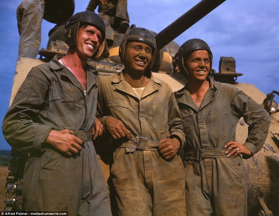 The war effort at home:  An M-4 tank crew is seen smiling for the camera of Alfred T Palmer at Fort Knox, June, 1942