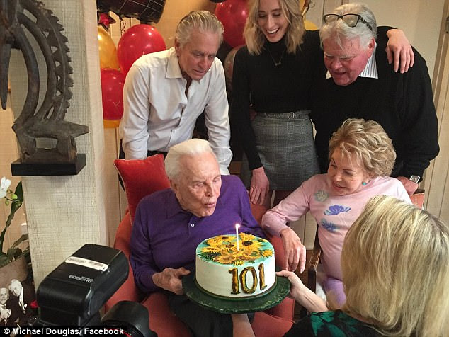 Make a wish! Sitting beside his wife Anne, the star blew out a single candle on his cake