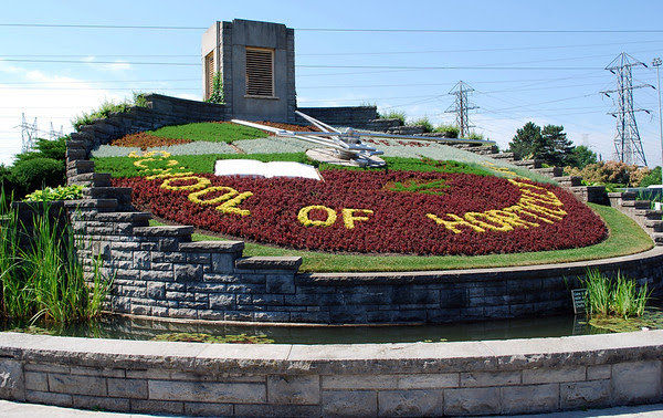 The Floral Clock at Queenston was built by Ontario Hydro in 1950; the planted face is maintained by Niagara Parks horticulture staff while the mechanism is kept in working order by Ontario Hydro. The floral design is changed twice each year with up to 16,000 carpet bedding plants.