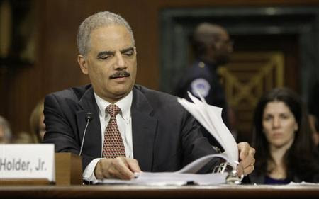 U.S. Attorney General Eric Holder refers to his notes during testimony before the Senate Judiciary Committee on Capitol Hill in Washington, March 6, 2013. REUTERS/Jonathan Ernst