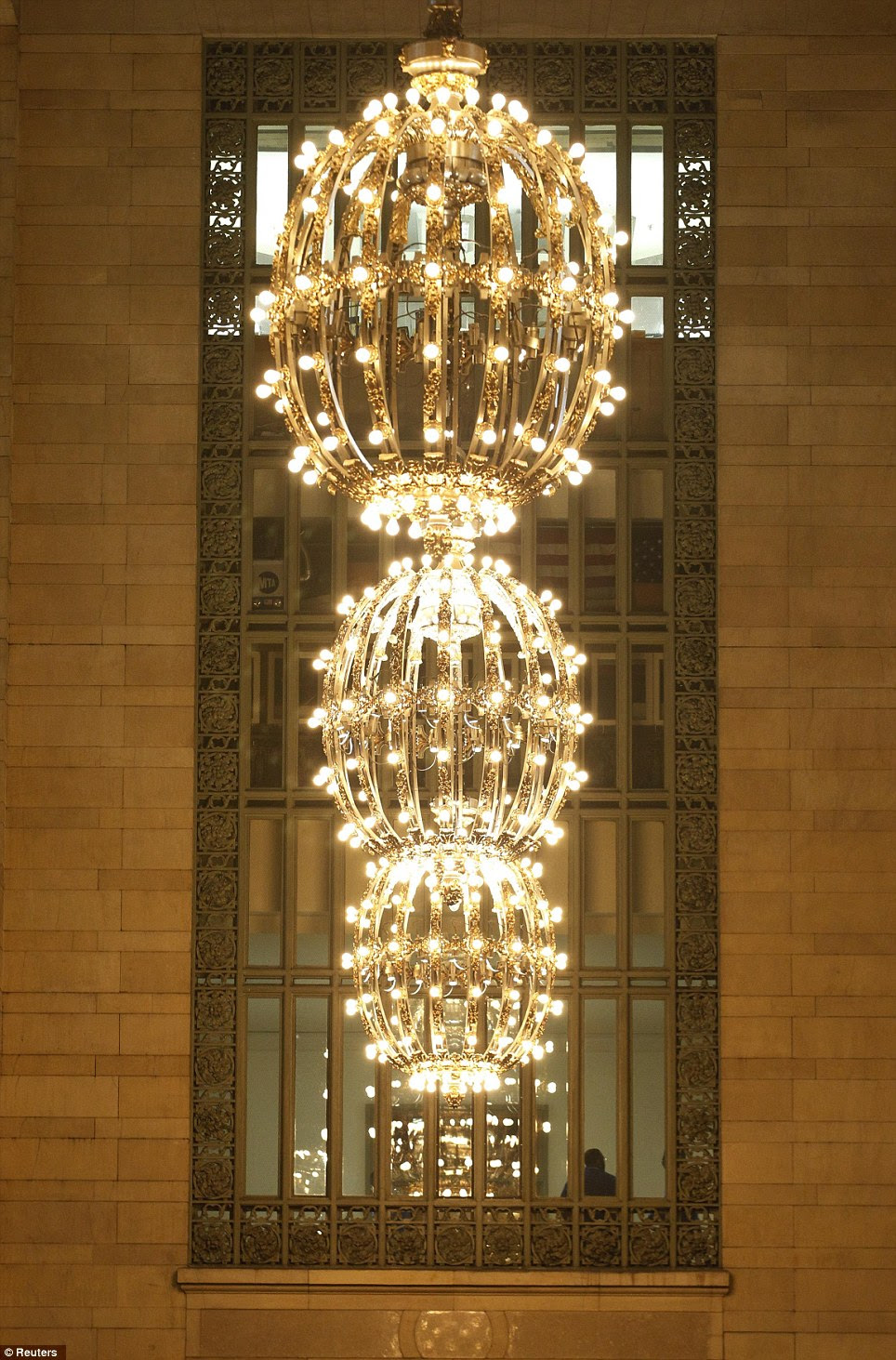 A large gold plated chandeliers hangs off the main concourse