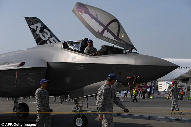 US military personnel escort a Lockheed Martin F-35 fighter jet towards the runway at the International Paris Air Show in Le Bourget outside Paris