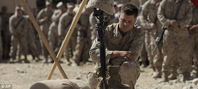 Silent tribute: U.S. Marine Corporal Braxton Russell pays his respects to Lance Cpl. Bernard during a memorial service in Afghanistan
