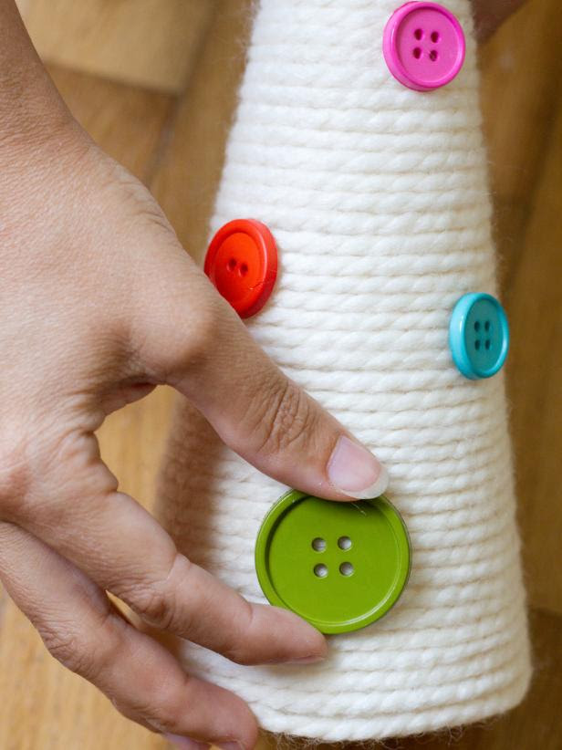 Cover the cone with a variety of medium and large buttons, attaching them with hot glue.