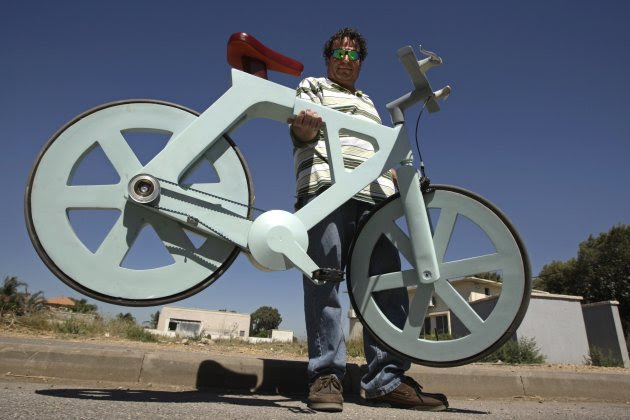 Israeli inventor Izhar Gafni holds his cardboard bicycle as he poses for a photo in Moshav Ahituv, central Israel September 24, 2012. The bicycle, made almost entirely of cardboard, has the potential to change transportation habits from the world's most congested cities to the poorest reaches of Africa, Gafni, an expert in designing automated mass-production lines and an amateur cycling enthusiast, says. Picture taken September 24, 2012. To match ISRAEL-CARDBOARDBIKE/ REUTERS/Baz Ratner (ISRAEL - Tags: ENVIRONMENT SPORT CYCLING SOCIETY) Israeli inventor Izhar Gafni holds his cardboard bicycle as he poses for a photo in Moshav Ahituv, central Israel September 24, 2012. The bicycle, made almost entirely of cardboard, has the potential to change transportation habits from the world's most congested cities to the poorest reaches of Africa, Gafni, an expert in designing automated mass-production lines and an amateur cycling enthusiast, says. Picture taken September 24, 2012. To match ISRAEL-CARDBOARDBIKE/ REUTERS/Baz Ratner (ISRAEL - Tags: ENVIRONMENT SPORT CYCLING SOCIETY)