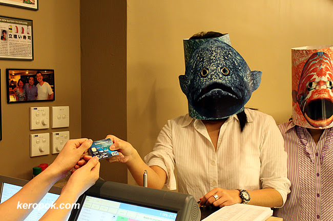 Barry and Fin paying with the Standard Chartered Card