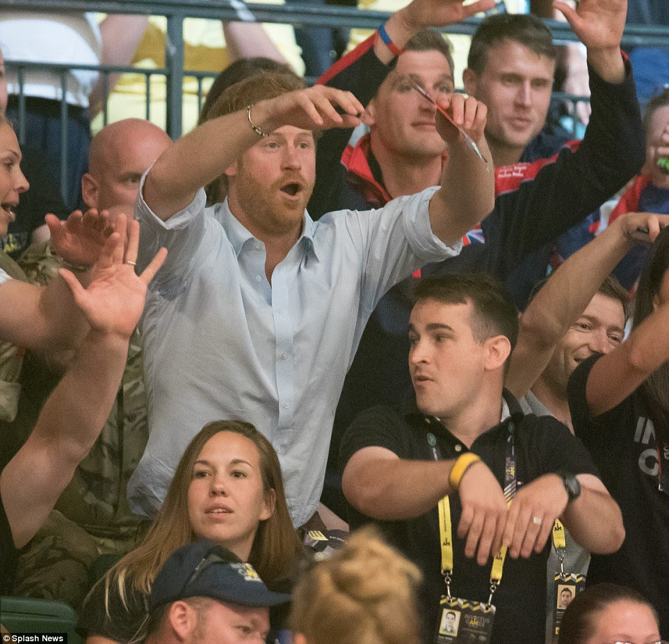Bit hot Harry? The prince took part in The Wave at the wheelchair rugby event at the Invictus Games - revealing sweat patches under his arms