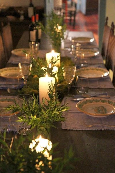 Simple olive branches and candlelight. Rosemary branches would work also and smell so divinely Italian!