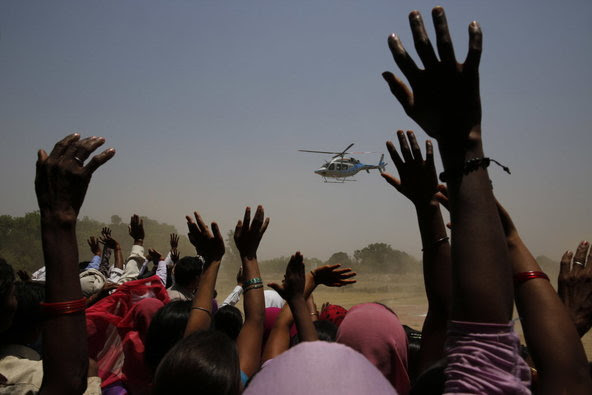 Supporters waving at a helicopter carrying Akhilesh Yadav, chief minister of the northern Indian state of Uttar Pradesh, at a rally on the outskirts of Allahabad on Wednesday.