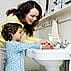 Take everyday preventive actions to stop the spread of germs like this mother teaching her young child to wash hands.