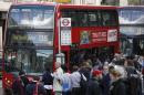 A bus waits at a bus-stop during rush hour outside Liverpool Street station in London