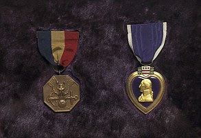 Framed together are the Navy Marine Corps Medal and the Purple Hearttial