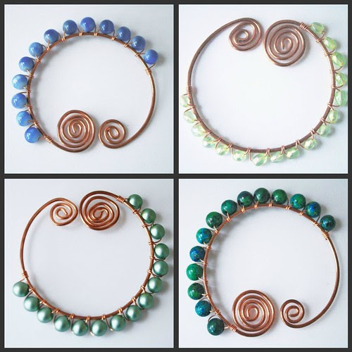 An assortment of shawl pins in cool colors