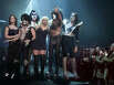 Smith is surrounded by members of KISS at the conclusion of the Spring/Summer Lane Bryant Lingerie Fashion Show in New York City in 2002.