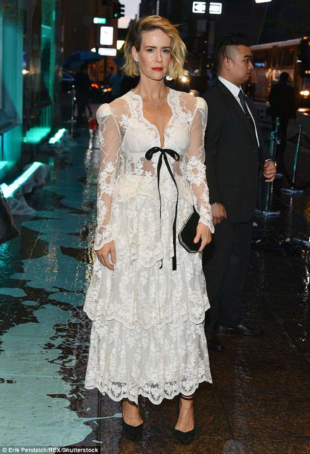 Stand out! While Paulson opted for a semi-sheer design and a low cut neckline with a black bow at the center of her chest