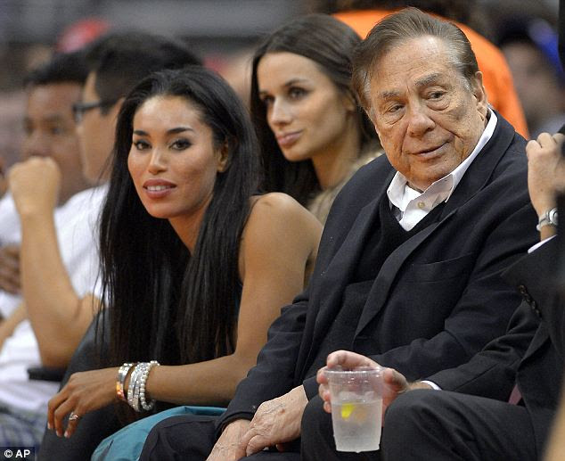 Damning recording: Donald Sterling (center) can be heard telling his girlfriend V. Stiviano (to his left) not to bring black people to Clippers games