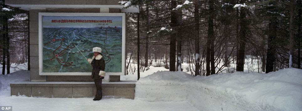 On duty: A female North Korean soldier, working as a guide, stands before a map to explain the layout of what is said to 