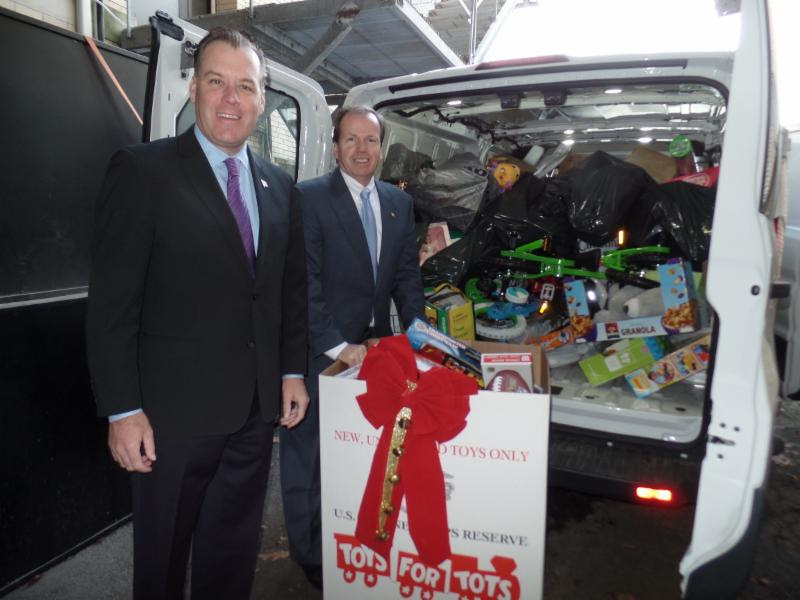 From left to right: Treasurer Jim Timilty and Register Bill O'Donnell loading up the Toys for Tots Van!