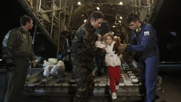 Rescued passengers of the "Norman Atlantic" accident, Marko Gondolo, second left, 40, and his daughter Serafina, 5, arrive from Italy at Elefsina Air Base outside Athens, on Monday, Dec. 29, 2014.