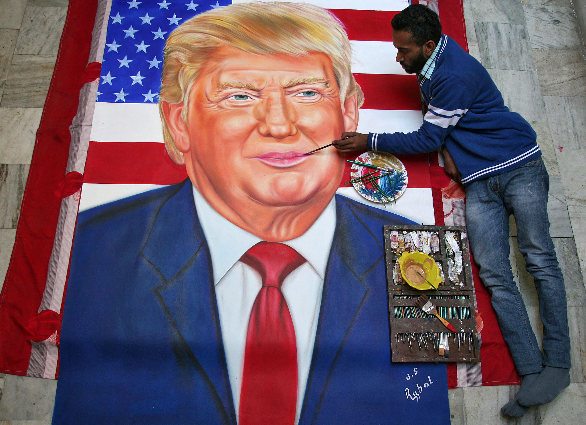 Jagjot Singh Rubal, an Indian artist, gives final touches to a portrait of U.S. President-elect Donald Trump ahead of Trump's inauguration at his workshop in Amritsar, India, January 19, 2017. REUTERS/Munish Sharma FOR EDITORIAL USE ONLY. NO RESALES. NO ARCHIVES.