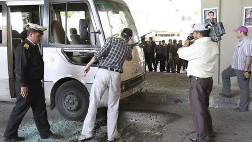 Syrian security forces inspect a truck damaged in an explosion outside a mosque on April 27, 2012. The attacks are a continuation of bombings carried out by opposition forces against the government of President Bashar al-Assad in Damascus. by Pan-African News Wire File Photos