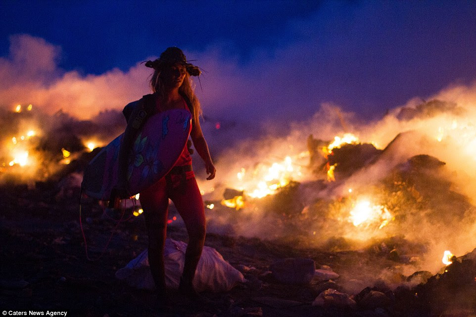 Burning waste: Alison walks through plastic on Thilafushi - an artificial island in the Maldives which is a dumping ground for rubbish