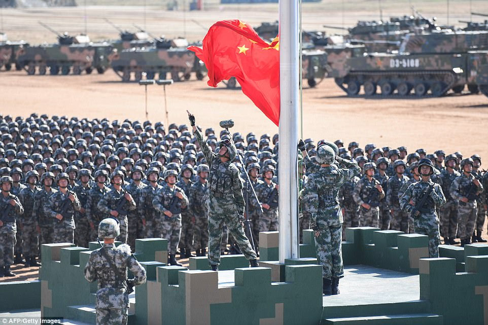 The Chinese flag is raised during a military parade at the Zhurihe training base in China's northern Inner Mongolia region