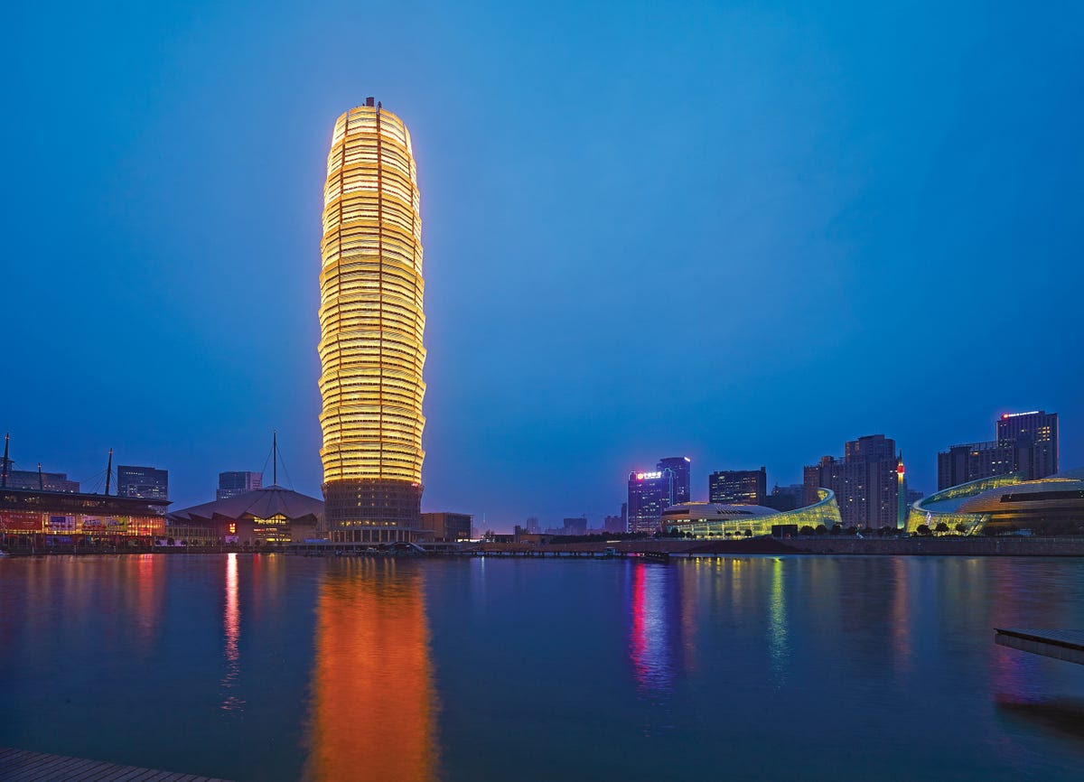 #9 (TIE) ZHENGZHOU GREENLAND PLAZA — Located in Zhengzhou, China, the Zhengzhou Greenland Plaza houses office space and a 435-room hotel. The tower includes a mirror at the top that reflects sunlight down into the hotel's atrium.