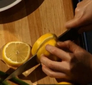The blind chef is seen deftly cutting into her ingredients including a lemon