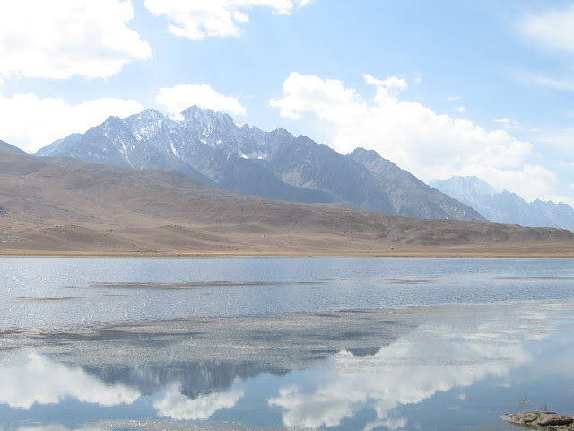 Mountains reflected in the waters of the lake at the top of the Shandur Pass (3)