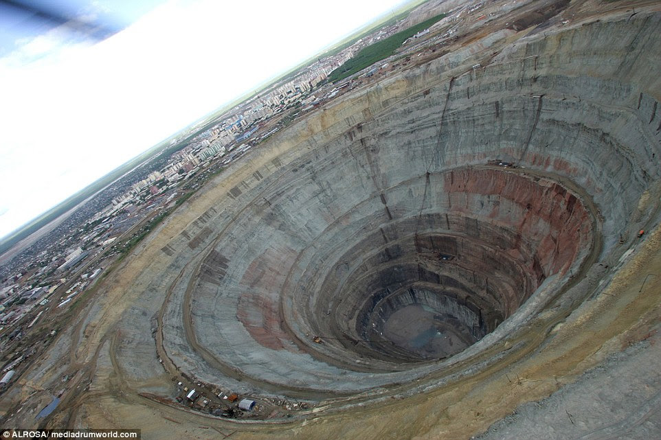 At 1,722-feet-deep and with a diameter of nearly one mile, the crater makes it look like the nearby town of Mirny has been struck by a meteorite
