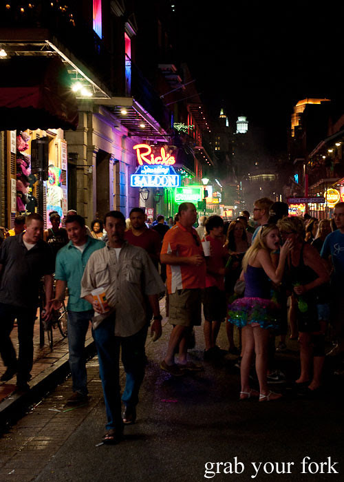 bourbon street at night partygoers in new orleans louisiana