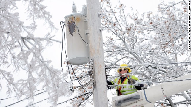 Dave Dora, with Grand Haven Board of Light and Power, works on fallen wires in Lansing, Michigan. on December 23, 2013. 