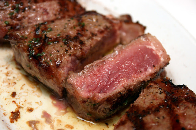 The steaks are done just right, with just salt and pepper for seasoning, finished with chopped parsley and melted butter