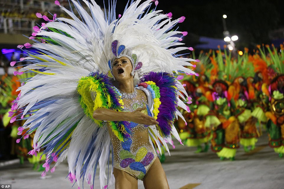 Outlandish: Dancers wore incredible feather headdresses and brightly coloured outfits as they took part in the glittering display