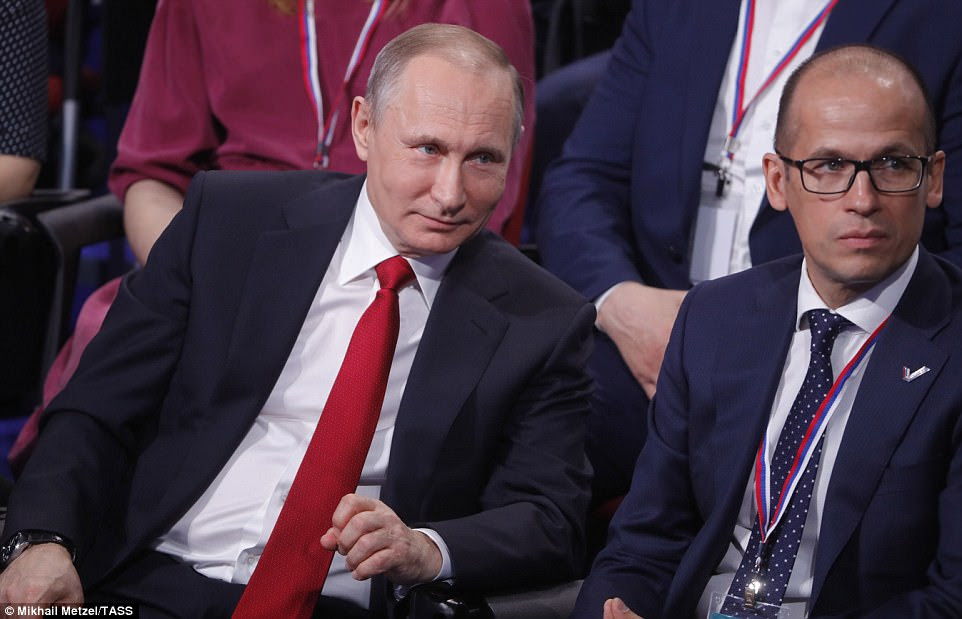 Russia's President Vladimir Putin (L) and Russian Civic Chamber Secretary Alexander Brechalov attend the 4th Truth and Justice Independent Regional and Local Media Forum held by the All-Russian People's Front