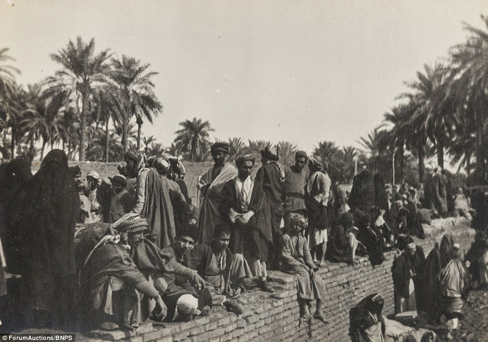 Later on that year, the Arab revolt, in which Lawrence of Arabia was a central figure, was launched against the Ottoman Empire. Lessons were learned from the fall of Kut and after several decisive triumphs, Baghdad was captured in March 1917. This image shows a group of people waiting together in Baghdad on a pier head