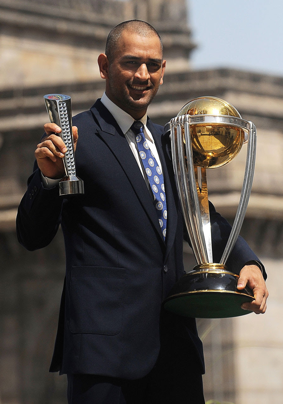 MS Dhoni with the World Cup trophy and his Man of the Match award from the final MS Dhoni with the World Cup trophy and his Man of the Match award from the final