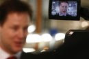 Britain's Deputy Prime Minister Nick Clegg is seen in a camera viewfinder as he speaks to members of the media at the Aston Martin production facility in Gaydon