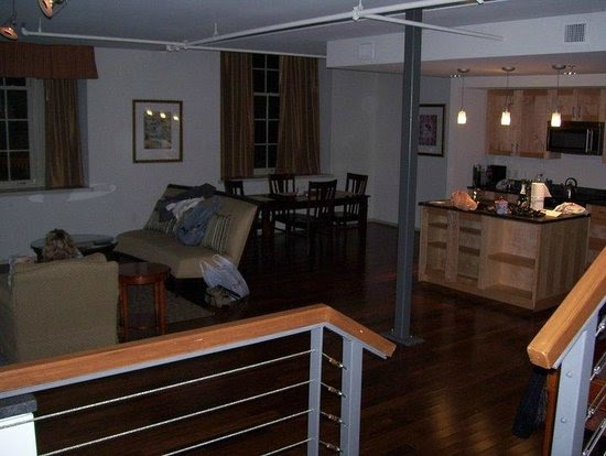 A shot of the living room and kitchen, shot from the steps to the