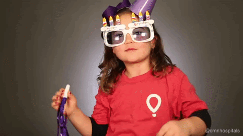 Little girl in Children's Miracle Network Hospitals T-shirt, party hat, and goofy party glasses, doing a little victory dance.