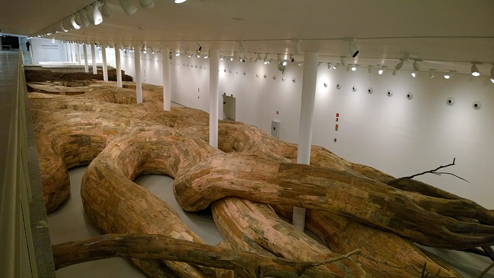 Artist Henrique Oliveira Constructs a Cavernous Network of Repurposed Wood Tunnels at MAC USP Artist Henrique Oliveira Constructs a Cavernous Network of Repurposed Wood Tunnels at MAC USP wood installation architecture