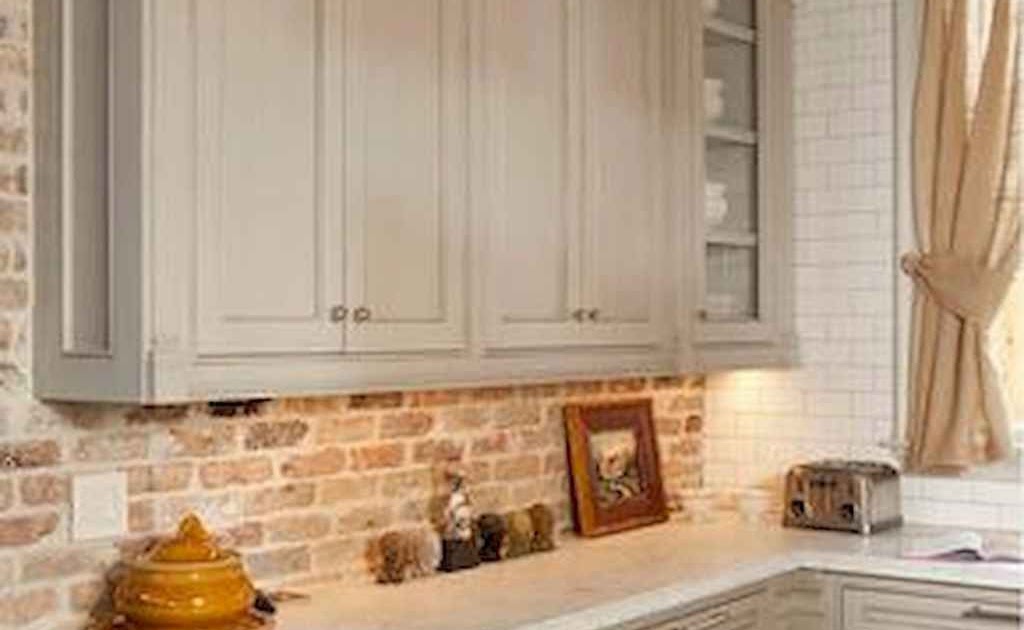 installing kitchen cabinet brick wall