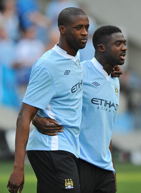 Manchester City's Ivorian Midfielder Yaya Toure (L) Celebrates With His Brother Kolo Toure (R) On The Pitch
AFP/Getty Images