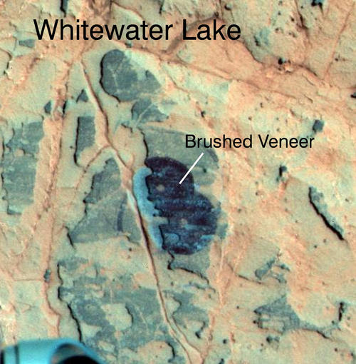 Researchers used NASA's Mars Exploration Rover Opportunity to find a water-related mineral on the ground that had been detected from orbit, and found it in the dark veneer of rocks on the rim of Endeavour Crater.