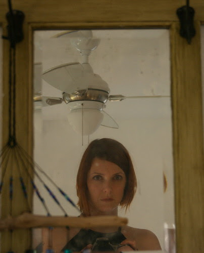 dirty mirror, ceiling fan, driftwood glass wind chime, and me.