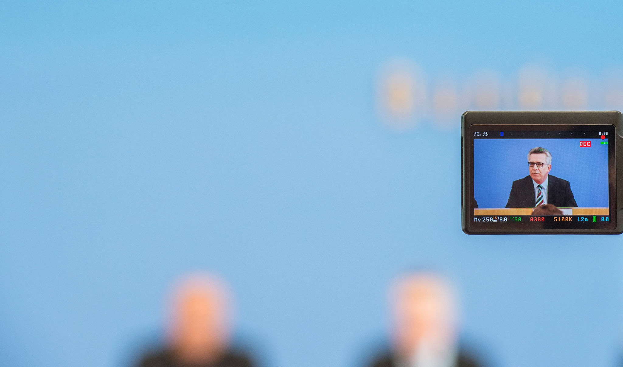 A camera screen shows German Interior Minister Thomas de Maiziere as he addresses a press conference after releasing the crime statistics in Germany for 2015, in Berlin on May 23, 2016. / AFP PHOTO / John MACDOUGALLJOHN MACDOUGALL/AFP/Getty Images